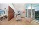 Open living room with high ceilings, light hardwood floors and large windows overlooking pool at 2945 Pyrula Dr, Longboat Key, FL 34228