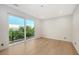 Bright bedroom with sliding doors to private balcony at 2945 Pyrula Dr, Longboat Key, FL 34228