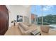 Spacious living room with high ceilings, light hardwood floors and large windows at 2945 Pyrula Dr, Longboat Key, FL 34228