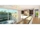 Second floor hallway with glass railing, elevator, and pool view at 2945 Pyrula Dr, Longboat Key, FL 34228