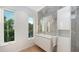 Modern bathroom with floating vanity, large mirror, and window views at 2945 Pyrula Dr, Longboat Key, FL 34228