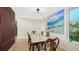 Bright dining room featuring a large artwork and elegant dining table at 2945 Pyrula Dr, Longboat Key, FL 34228