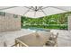 Relaxing patio with pool, spa, and outdoor dining area at 2945 Pyrula Dr, Longboat Key, FL 34228