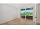 Bright bedroom with hardwood floors and sliding glass door to patio at 2945 Pyrula Dr, Longboat Key, FL 34228
