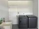 Laundry room with washer, dryer, utility sink and built-in cabinets at 906 Southern Pine Ln, Sarasota, FL 34243