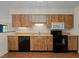 Kitchen with wood cabinets, black appliances, and light countertops at 4109 66Th Street W Cir # 4109, Bradenton, FL 34209
