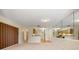 Open living room with mirrored wall and view of kitchen at 4109 66Th Street W Cir # 4109, Bradenton, FL 34209