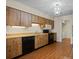 Kitchen with wood cabinets and black appliances at 4109 66Th Street W Cir # 4109, Bradenton, FL 34209