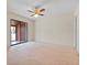 Bedroom with carpet, ceiling fan, and sliding glass doors to patio at 4109 66Th Street W Cir # 4109, Bradenton, FL 34209