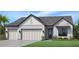 Two-story home with a three-car garage and a landscaped yard at 2521 Waterfront Cir, Sarasota, FL 34240