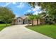 Single-story home with a landscaped yard, driveway, and two palm trees at 815 128Th Ne St, Bradenton, FL 34212