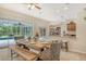 Dining area with a wooden table, bench seating, and access to the pool at 815 128Th Ne St, Bradenton, FL 34212