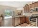 Modern kitchen with stainless steel appliances and view of pool and backyard at 815 128Th Ne St, Bradenton, FL 34212