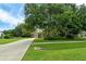 House exterior showing a tan home with landscaping and a long driveway at 815 128Th Ne St, Bradenton, FL 34212