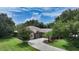 Aerial view of a single Gathering home with a large driveway and lush green lawn at 815 128Th Ne St, Bradenton, FL 34212