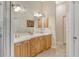 Elegant bathroom with double vanity, light wood cabinets, and marble flooring at 815 128Th Ne St, Bradenton, FL 34212