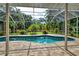 Enclosed pool area with brick pavers and lush landscaping at 815 128Th Ne St, Bradenton, FL 34212