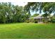 Spacious backyard with lush lawn and mature trees at 815 128Th Ne St, Bradenton, FL 34212
