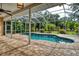 Inviting screened pool area with paver deck and lush landscaping at 815 128Th Ne St, Bradenton, FL 34212