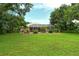 Large grassy backyard with mature trees at 815 128Th Ne St, Bradenton, FL 34212