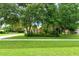 House exterior showcasing a single-story home with lush landscaping and a long driveway at 815 128Th Ne St, Bradenton, FL 34212