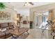 Bright living room with leather sofas, wooden coffee table, and view to backyard at 815 128Th Ne St, Bradenton, FL 34212
