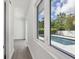 Bright hallway with gray flooring and sliding glass doors leading to a view of the pool at 2234 Hibiscus St, Sarasota, FL 34239