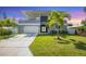 Modern two-story house with gray facade and palm trees at 2234 Hibiscus St, Sarasota, FL 34239