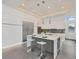 Bright kitchen featuring white cabinets, an island, and mosaic backsplash at 2234 Hibiscus St, Sarasota, FL 34239