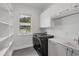 Bright laundry room with washer, dryer, and ample storage at 2234 Hibiscus St, Sarasota, FL 34239