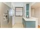 Kitchen with stainless steel appliances and teal cabinets at 184 Pineneedle Dr # 184, Bradenton, FL 34210