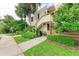 Condo building exterior showcasing a staircase and tropical landscaping at 184 Pineneedle Dr # 184, Bradenton, FL 34210