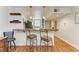 Kitchen with a live-edge breakfast bar, teal cabinets and modern appliances at 184 Pineneedle Dr # 184, Bradenton, FL 34210