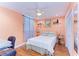 Cozy bedroom with peach walls, a comfortable bed, and built-in shelving at 184 Pineneedle Dr # 184, Bradenton, FL 34210