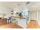 Eat-in kitchen with a live-edge breakfast bar and teal cabinetry at 184 Pineneedle Dr # 184, Bradenton, FL 34210