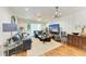 Bright living room featuring hardwood floors, comfortable seating, and a large TV at 184 Pineneedle Dr # 184, Bradenton, FL 34210