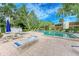 Community pool with lounge chairs and patio area at 184 Pineneedle Dr # 184, Bradenton, FL 34210