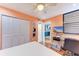 Bedroom with built-in desk and view of kitchen at 184 Pineneedle Dr # 184, Bradenton, FL 34210