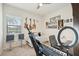 Bedroom features guitars and musical art, neutral décor, a ceiling fan, and a window with neighborhood views at 13215 Ramblewood Trl, Bradenton, FL 34211