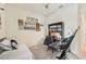 Bedroom features a bed, desk, and musical decorations, a ceiling fan, and neutral decor at 13215 Ramblewood Trl, Bradenton, FL 34211