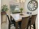 Charming dining area with a square table, comfortable chairs, and stylish decor at 13215 Ramblewood Trl, Bradenton, FL 34211