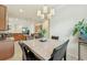 Cozy dining area showcases a square table, comfortable chairs, and stylish chandelier at 13215 Ramblewood Trl, Bradenton, FL 34211