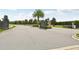The gated entrance to a secure and private community, surrounded by mature trees and landscaping at 13215 Ramblewood Trl, Bradenton, FL 34211