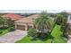 Beautiful front exterior showcasing a brick driveway, mature landscaping, and a two-car garage at 13215 Ramblewood Trl, Bradenton, FL 34211