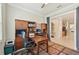 Cozy home office featuring wooden desk, built in shelving, and ceiling fan at 13215 Ramblewood Trl, Bradenton, FL 34211