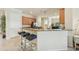 Kitchen featuring breakfast bar with seating, wood cabinets, and view into breakfast nook at 13215 Ramblewood Trl, Bradenton, FL 34211