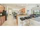 Open kitchen featuring granite counters, breakfast bar, stainless appliances and adjacent living area at 13215 Ramblewood Trl, Bradenton, FL 34211