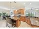 Kitchen showcases granite countertops, wood cabinets and open layout to the breakfast nook at 13215 Ramblewood Trl, Bradenton, FL 34211