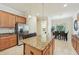 Kitchen showcasing granite island, stainless appliances, and breakfast nook in the background at 13215 Ramblewood Trl, Bradenton, FL 34211