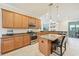 Modern kitchen boasts wood cabinetry, granite counters, stainless appliances, and breakfast bar at 13215 Ramblewood Trl, Bradenton, FL 34211